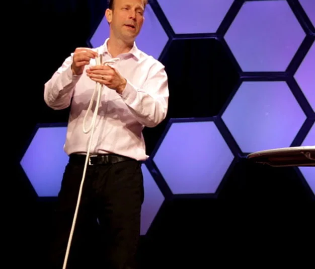 Bruce Eicher performing a rope illusion onstage.