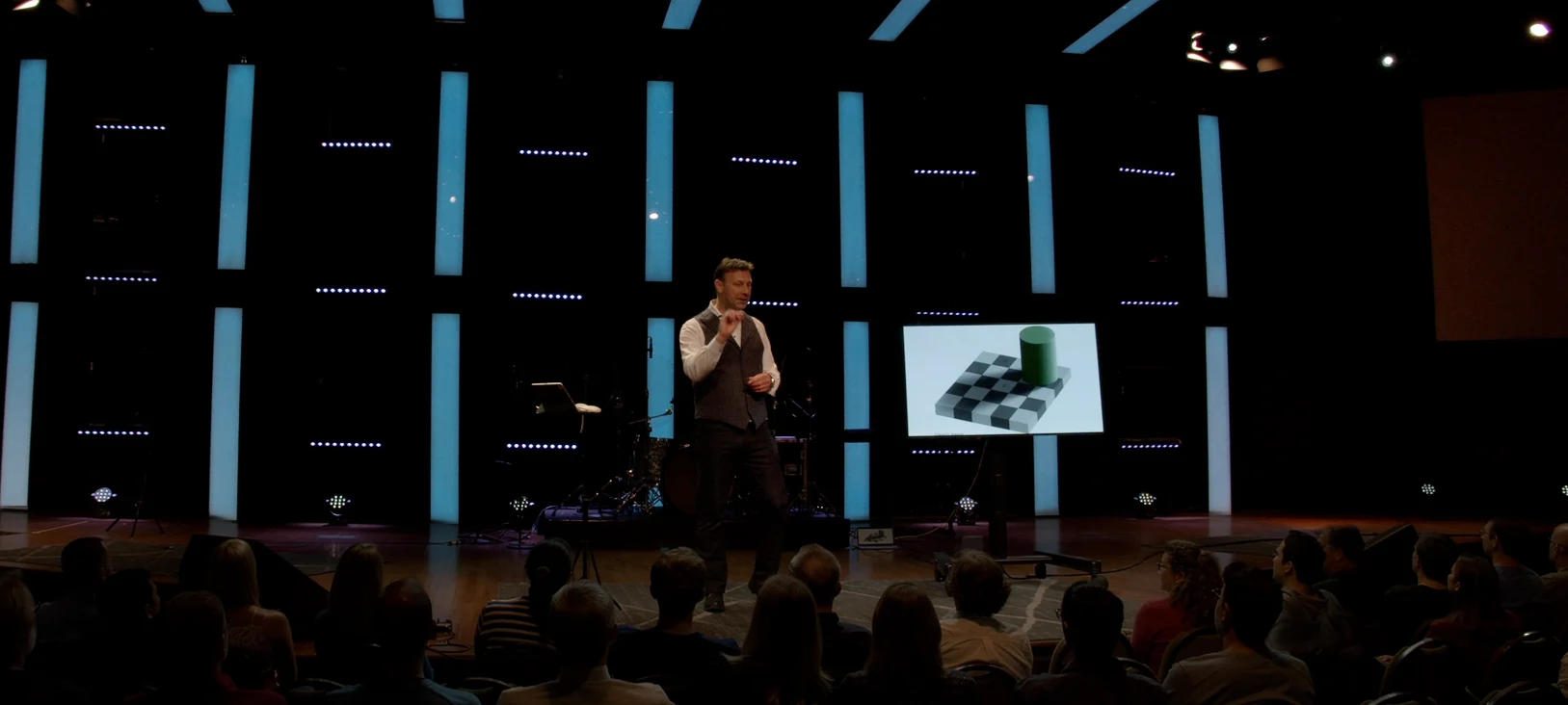 Bruce Eicher demonstrating visual perspective onstage in front of an audience.