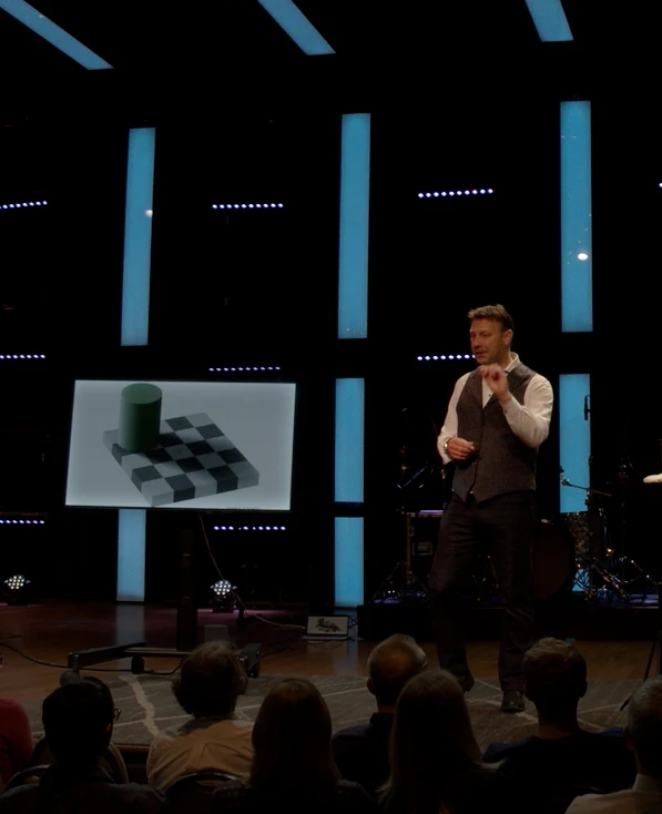Bruce Eicher presenting a visual demonstration to a live audience.