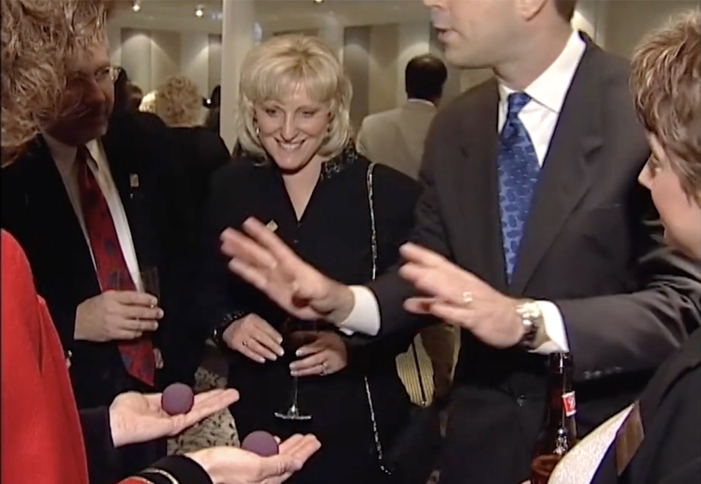 Corporate event guests gathered around Bruce Eicher for close-up magic.