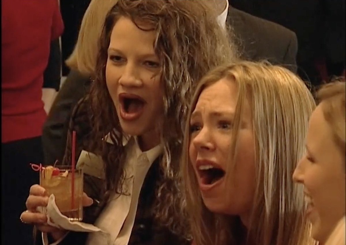Two guests reacting with surprise to close-up magic.